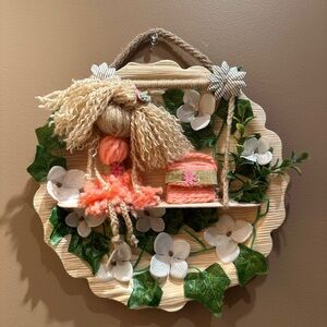 Decorative Yarn Doll Wall Hanging with Floral Accents